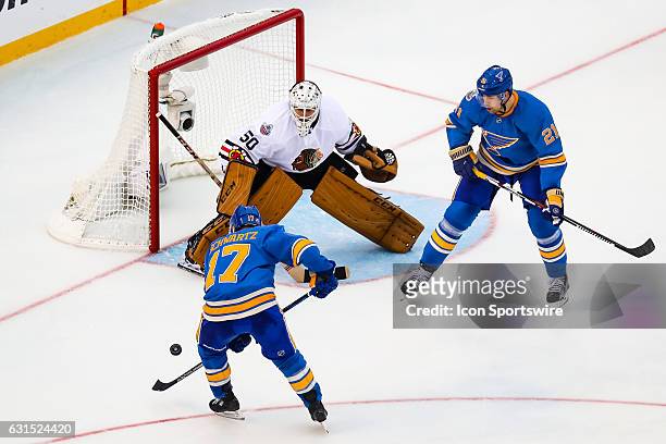 St. Louis Blues Left Wing Jaden Schwartz attempts to settle a bouncing puck in front of Chicago Blackhawks Goalie Corey Crawford during the third...