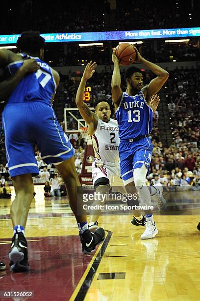 Matt Jones guard Duke University Blue Devils attempts to pass the basketball while being defended by CJ Walker guard Florida State University...