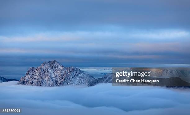 snow peak - mountain peak above clouds stock pictures, royalty-free photos & images