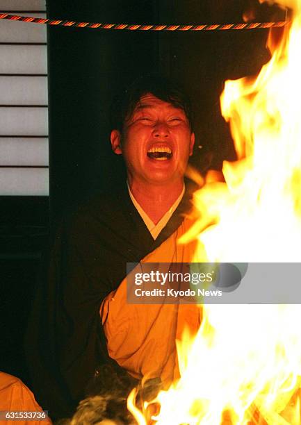 Takahiro Arai of the Hiroshima Carp chants a Buddhist sutra in front of a fire for about 90 minutes at the Saifukuji temple in Kagoshima, Japan on...