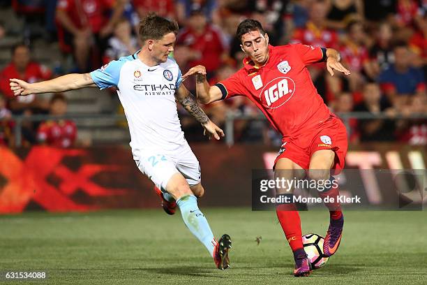 Michael Jakobsen of Melbourne City and Sergio Guardiola of Adelaide United compete for the ball during the round 15 A-League match between Adelaide...