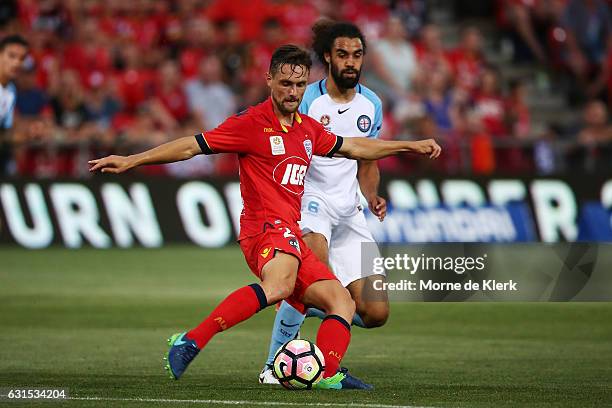 James Holland of Adelaide United gets away from Osama Malik of Melbourne City during the round 15 A-League match between Adelaide United and...