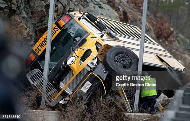 School bus sits on its side on Interstate 95 South after a rollover accident in Waltham, MA on Jan. 11, 2017.