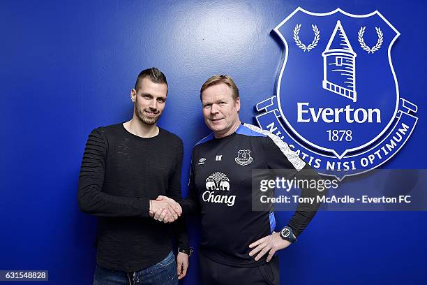 New Everton signing Morgan Schneiderlin is welcomed by Ronald Koeman at USM Finch Farm on January 11, 2017 in Halewood, England.