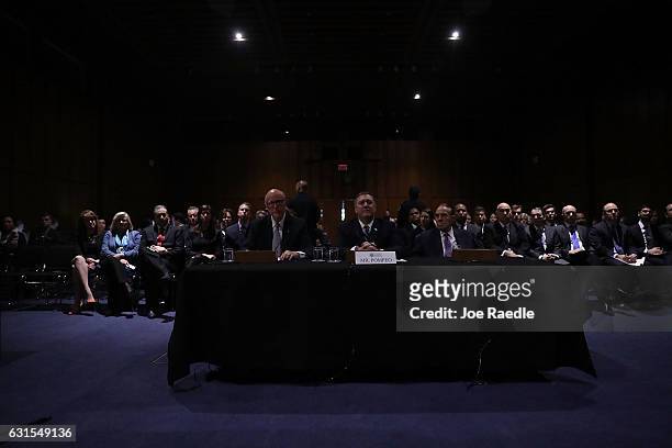 Sen. Pat Roberts , Rep. Mike Pompeo and former Sen. Bob Dole sit in the dimmed lights of their hearing room after the lights went out during Mr....