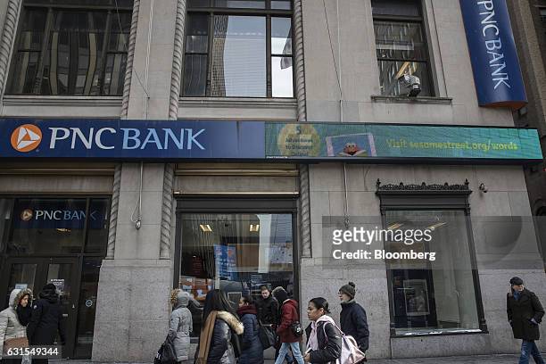 Pedestrians pass in front of a PNC Financial Services Group Inc. Bank branch in New York, U.S., on Monday, Jan. 9, 2017. PNC Financial Services Group...
