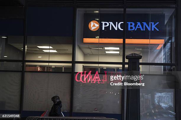 Pedestrian passes in front of a PNC Financial Services Group Inc. Bank branch in New York, U.S., on Monday, Jan. 9, 2017. PNC Financial Services...