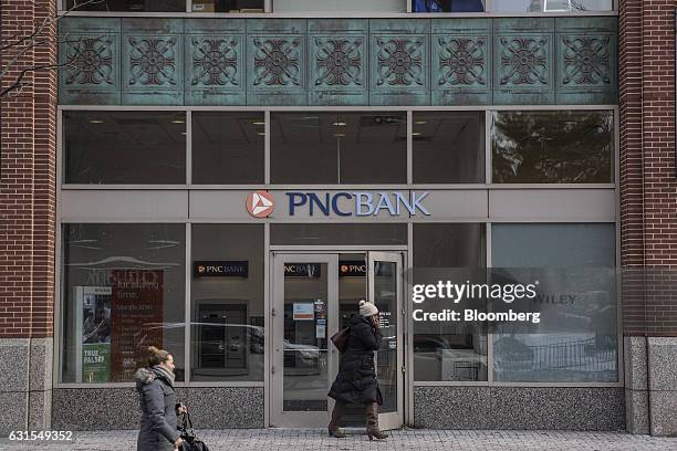 Pedestrians pass in front of a PNC Financial Services Group Inc. Bank branch in Hoboken, New Jersey, U.S., on Monday, Jan. 9, 2017. PNC Financial...