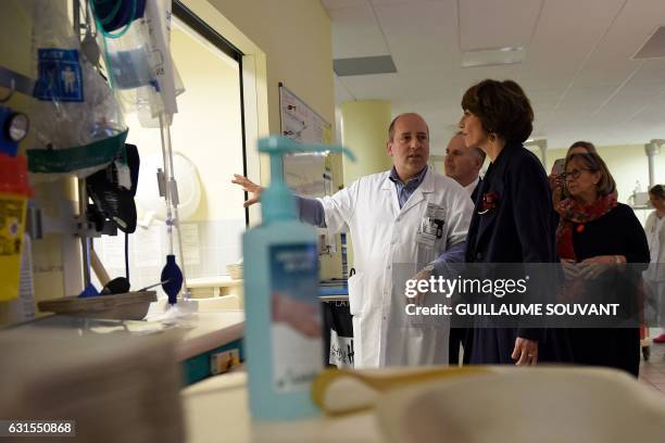 French Minister for Social Affairs and Health Marisol Touraine listens to a doctor as she visits the emergency department of the hospital Trousseau...