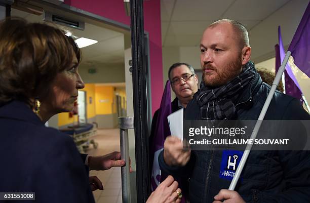French Minister for Social Affairs and Health Marisol Touraine listens to a man as she visits the emergency department of the hospital Trousseau in...
