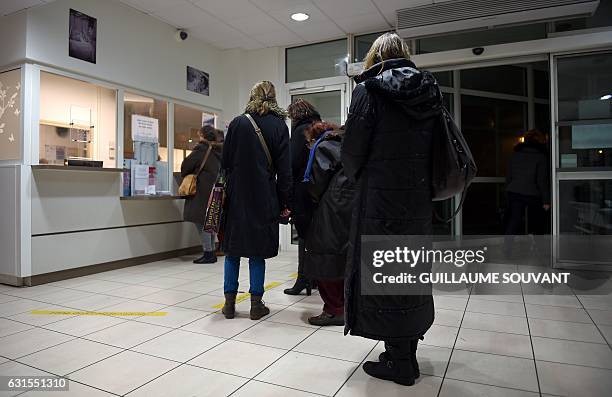 People wait inside the emergency department of the hospital of Trousseau in Tours on January 12, 2017 during a major flu epidemic in France. French...