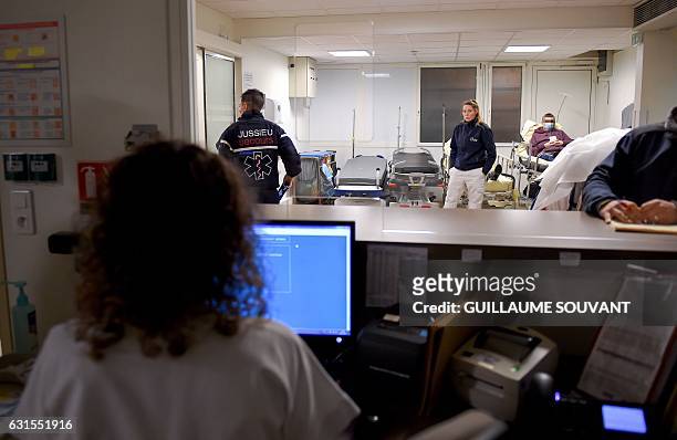 Patients and medical staff wait inside the emergency department of the hospital of Trousseau in Tours on January 12, 2017 during a major flu epidemic...