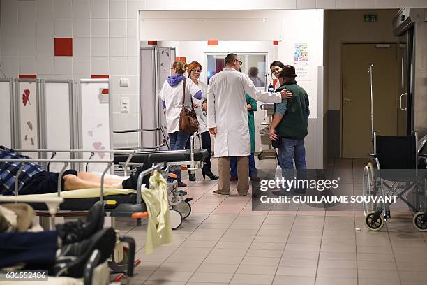 Medical staff speaks with patients at the emergency department of the hospital of Trousseau in Tours on January 12, 2017 during a major flu epidemic...