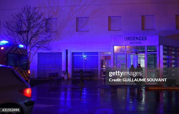 People wait at the entrance of the emergency department of the hospital of Trousseau in Tours on January 12, 2017. French hospitals are being...