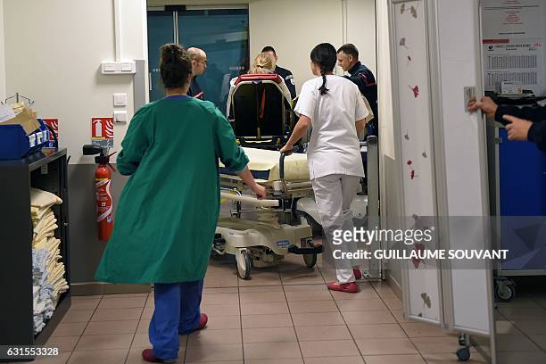 Medical staff work at the emergency department of the hospital of Trousseau in Tours on January 12, 2017 during a major flu epidemic in France....
