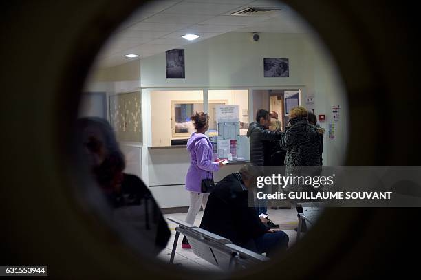 People wait at the reception of the emergency department of the hospital of Trousseau in Tours on January 12 during a major flu epidemic. French...