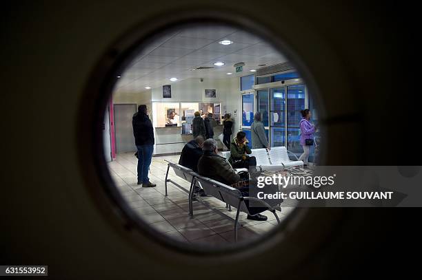 People wait at the reception of the emergency department of the hospital of Trousseau in Tours on January 12 during a major flu epidemic. French...