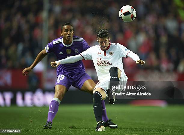 Danilo of Real Madrid CF competes for the ball with Sergio Escudero of Sevilla FC during the Copa del Rey Round of 16 Second Leg match between...