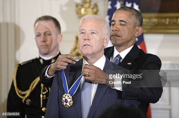 President Barack Obama presents the Medal of Freedom to Vice-President Joe Biden during an event in the State Dining room of the White House, January...