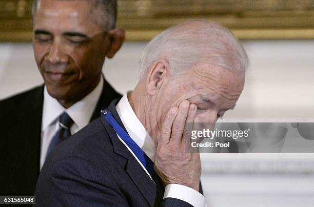 Vice President Joe Biden wipes his eyes after U.S President Barack Obama presented him with Medal of Freedom during an event in the State Dining room...