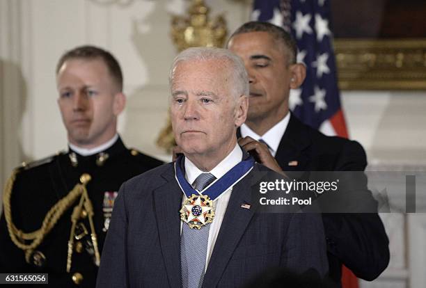 President Barack Obama presents the Medal of Freedom to Vice-President Joe Biden during an event in the State Dining room of the White House, January...