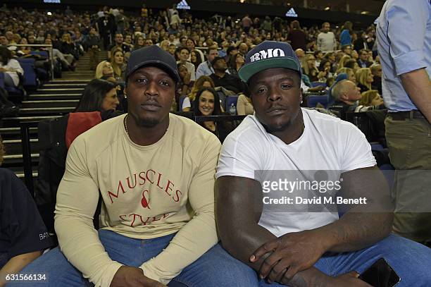 Adebayo Akinfenwa and guest sit courtside at the NBA Global Game London 2017 basketball game between the Indiana Pacers and Denver Nuggets at The O2...
