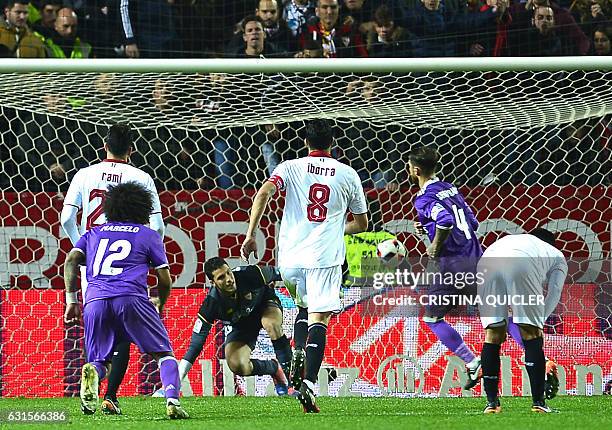 Real Madrid's defender Sergio Ramos reacts after scoring a goal during the Spanish Copa del Rey round of 16 second leg football match Sevilla FC vs...