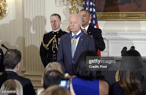 President Barack Obama presents the Medal of Freedom to Vice-President Joe Biden during an event in the State Dinning room of the White House,...