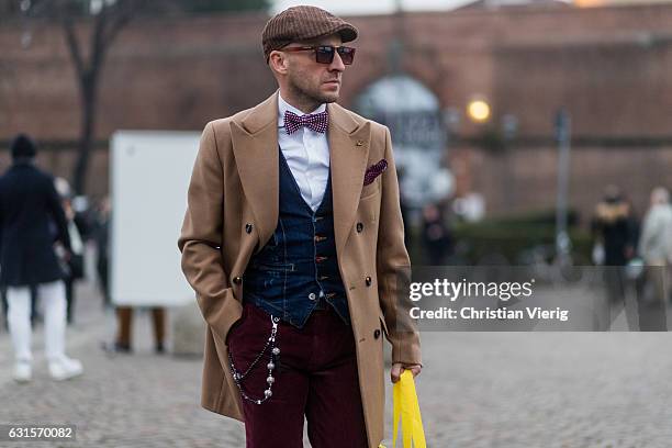 Guest is wearing a beige coat on January 12, 2017 in Florence, Italy.