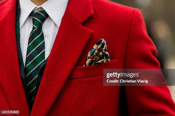 Ricardo Policano is wearing a red coat with pocket square, tie, red socks loafers on January 12, 2017 in Florence, Italy.