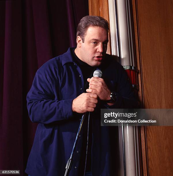Actor and comedia Kevin James poses for a portrait session onstage with a microphone in 1995 in Los Angeles, California .