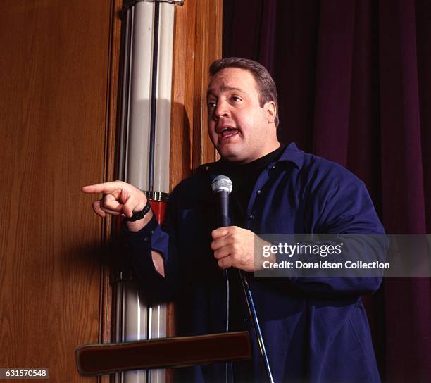 Actor and comedia Kevin James poses for a portrait session onstage with a microphone in 1995 in Los Angeles, California .