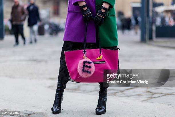 Elisa Mastella is wearing a Fendi Tote monster eye bag in saffiano and purple green coat, gloves on January 12, 2017 in Florence, Italy.