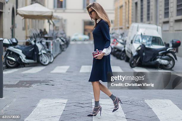 German fashion blogger and model Alexandra Lapp is wearing navy blue knee-length shirt dress in flared cut with removable wavy Peter Pan collar and...