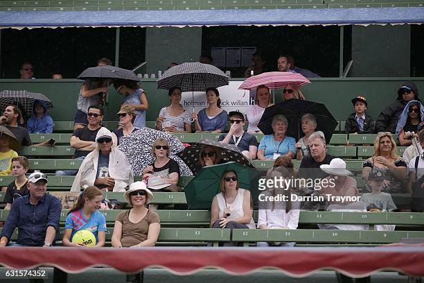 Light rain begins to fall during the match between Bernard Tomic of Australiaand Gilles Simon of France during day four of the 2017 Priceline...
