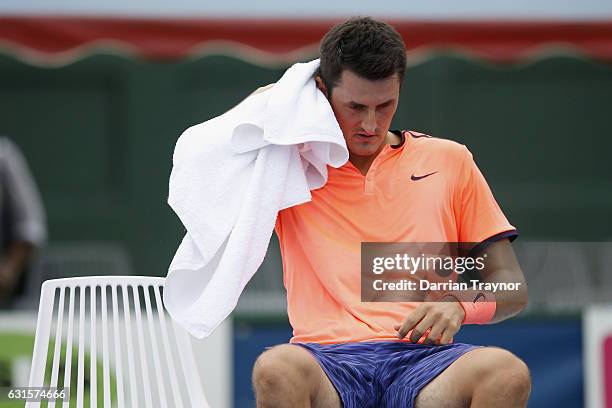 Bernard Tomic of Australia wipes sweat awat during a change of ends in his match against Gilles Simon of Franceduring day four of the 2017 Priceline...
