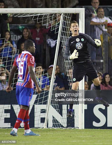 Goal keeper Alexander Brunst of German club VFL Wolfsburg celebrates after blocking a kick by Antonio Aquino of Brazilian club EC Bahia during their...