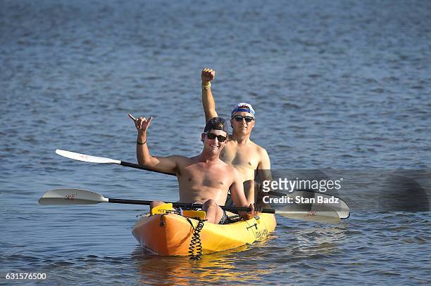 Smylie Kaufman and Jordan Spieth enjoy a kayak ride paddling along the water in front of the 17th hole during the first round of the Sony Open in...