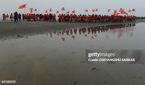 Indian Hindu devotees arrive to take a holy bath and to perform rituals in the Bay of Bengal at the mouth of the river Ganges in Sagar Island, around...