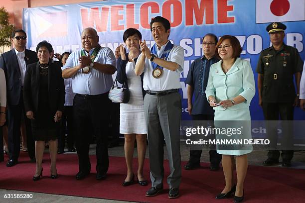 Japan's Prime Minister Shinzo Abe and wife Akie greet students at the Mindanao Kokusai Daigaku in Davao City on January 13, 2017. Abe is the first...