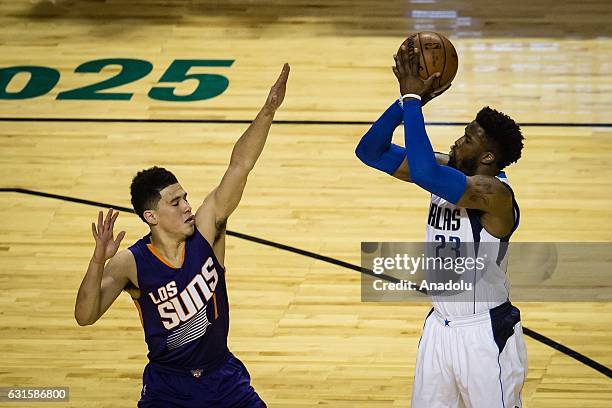 Devin Booker of Phoenix Suns struggle for the ball against Wesley Matthews of Dallas Mavericks during the NBA Game Mexico City between Phoenix Suns...