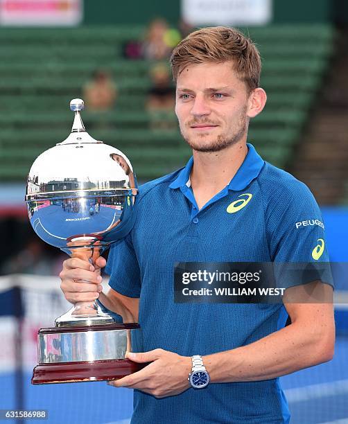 David Goffin of Belgium holds the trophy after winning the men's final against Ivo Karlovic of Croatia at the Kooyong Classic tennis tournament in...