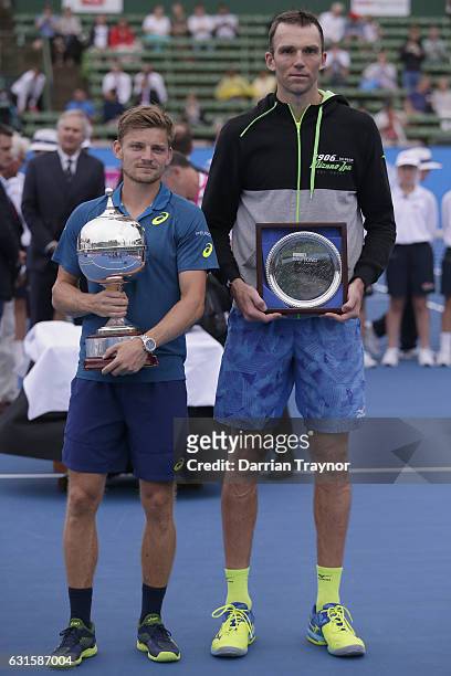 Champion David Goffin of Belgium and runner up Ivo Karlovic of Croatia pose for a photo during day four of the 2017 Priceline Pharmacy Classic at...