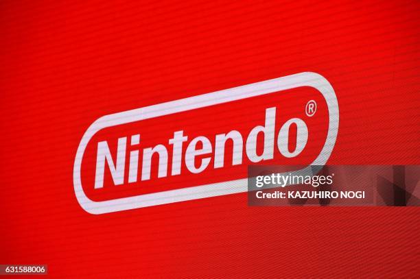 The logo of Japan's Nintendo Co. Is displayed at a presentation in Tokyo on January 13, 2017. Nintendo on January 13 unveiled its new Switch game...