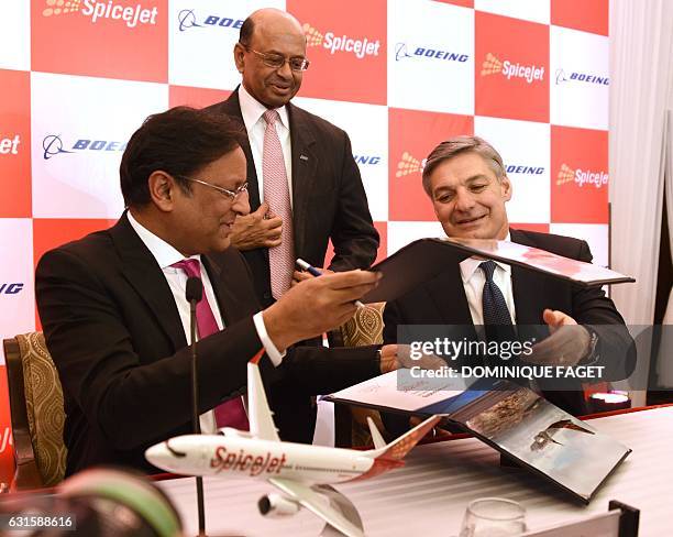 Spicejet Chairman Ajay Singh and Raymond L. Conner , Vice-Chairman of Boeing, exchange contracts at a press conference in New Delhi on January 13,...