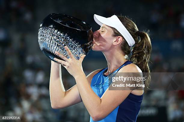 Johanna Konta of Great Britain poses with the winners trophy after the Womens Final match against Agnieszka Radwanska of Poland during the Sydney...