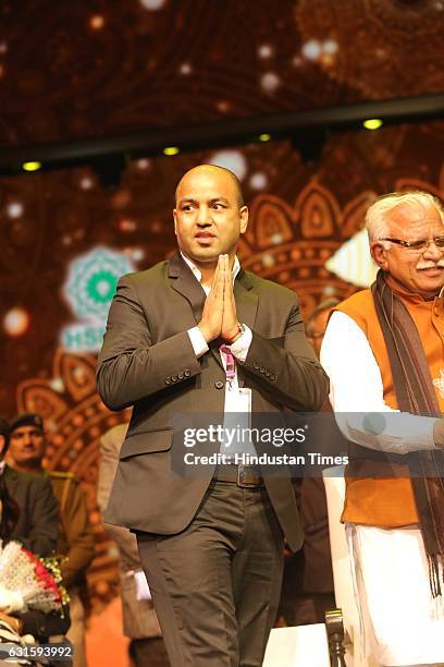 Commonwealth Games gold-medallist boxer Akhil Kumar with Haryana CM Manohar Lal Khattar during the first Pravasi Haryana Divas, organised by...