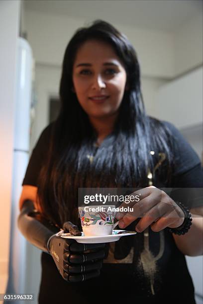 Amputee Zubeyde Nisa Karabacak, 26-years-old, serves Turkish coffee with her "bionic arm" named "Revo" during an exclusive interview at her home in...