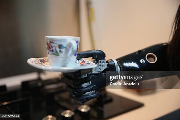 Amputee Zubeyde Nisa Karabacak, 26-years-old, serves Turkish coffee with her "bionic arm" named "Revo" during an exclusive interview at her home in...