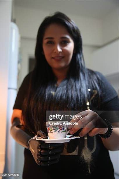 Amputee Zubeyde Nisa Karabacak, 26-years-old, serves Turkish coffee with her "bionic arm" named "Revo" during an exclusive interview at her home in...